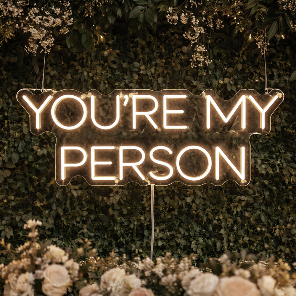 YOU'RE MY PERSON wedding neon sign mounted on floral wall