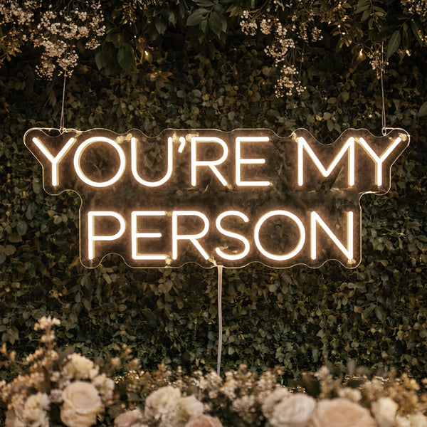 YOU'RE MY PERSON wedding neon sign mounted on floral wall
